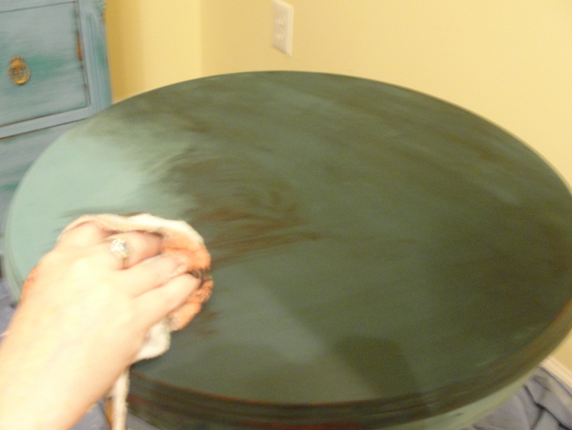 Hand rubbing the wax on the drum table